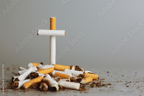 Stack of cigarette like graves.Cigarettes is addictive to be cancer.smoking reduction campaign in World No Tobacco Day. photo