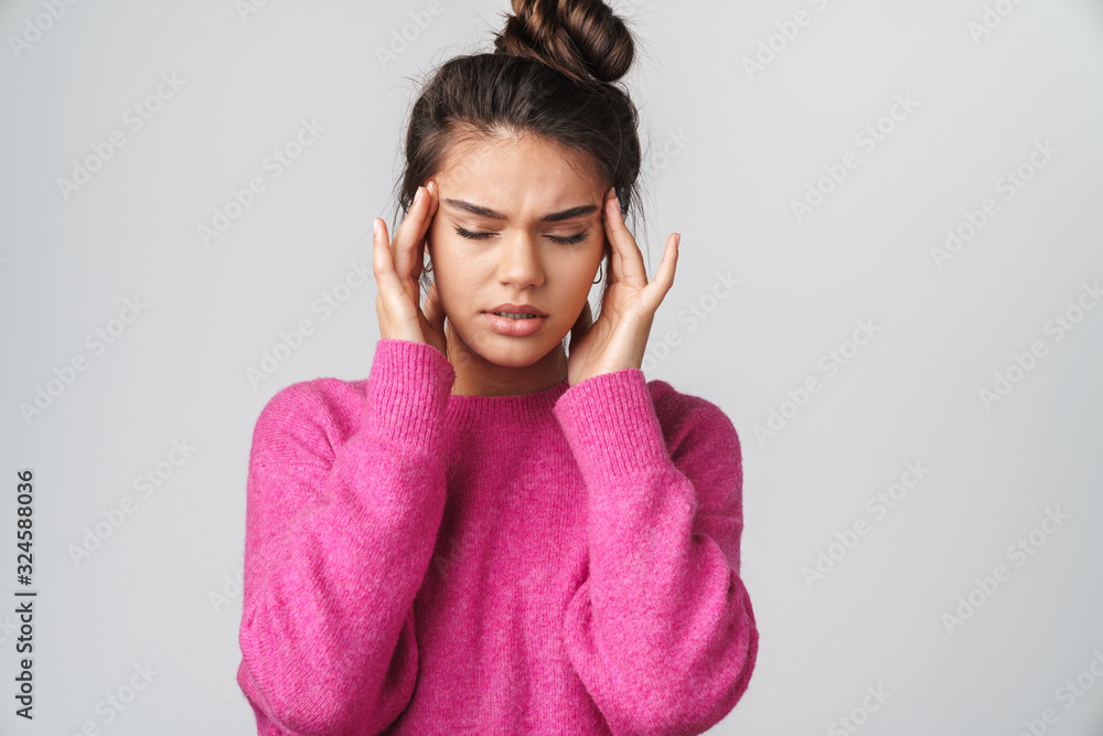 Image of nice unhappy woman with headache rubbing her temples Image of nice unhappy woman with headache rubbing her temples