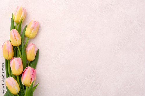 Fototapeta Naklejka Na Ścianę i Meble -  A bouquet of pink and yellow tulips on a background with copy space.