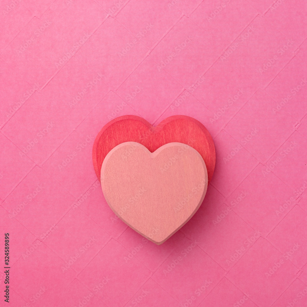 Fototapeta premium couple of wooden heart in love on red background. Hearts concept. Copy space.
