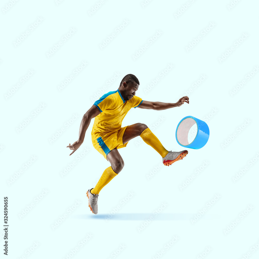 Soccer player kicking duct tape like a ball on blue background. Copyspace for your proposal. Modern design. Contemporary artwork, collage. Concept of sport, office, work, dreams, business, action.