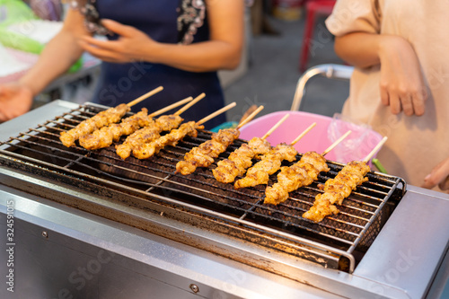 Crocodile meat grilled on a gas stove Sold at Amphawa floating market. Samut Songkhram Province, Thailand