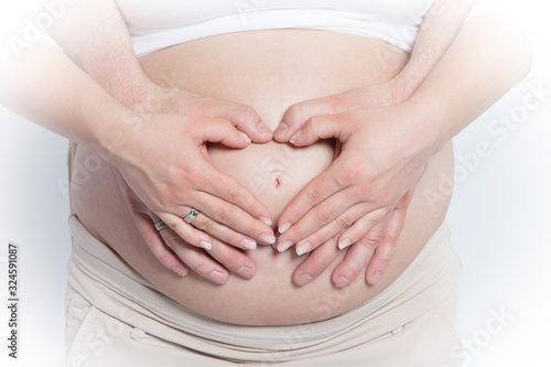The belly of a pregnant woman, she is waiting for a miracle