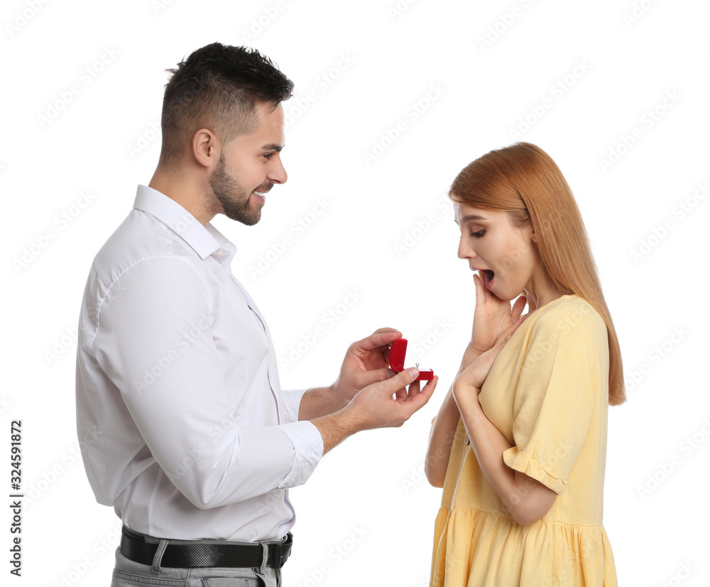 Man with engagement ring making marriage proposal to girlfriend on white background Man with engagement ring making marriage proposal to girlfriend on white background