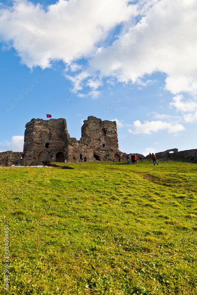 Tourists walk near the fortress of Yoros (Genoese fortress), Anadolu, Turkey