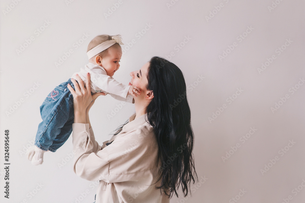 Mom and baby girl playing in sunny room. Mom and baby girl playing in sunny room.
