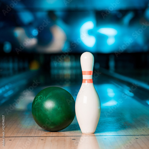 selective focus of bowling ball and skittle on skittle alley in bowling club Fototapeta