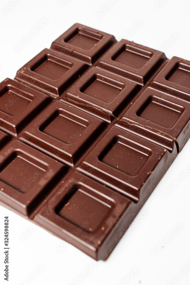 Dark chocolate pieces isolated on white background. Top view. Dark chocolate pieces isolated on white background. Top view.