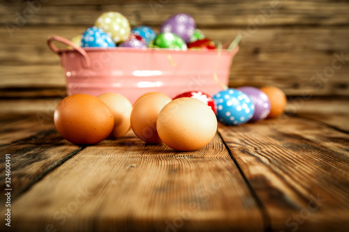 Easter eggs on wooden table and free space for your decoration. 