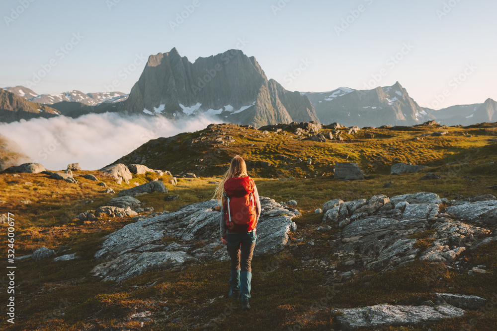 Woman traveler hiking in mountains with backpack adventure travel healthy lifestyle active summer vacations explore Norway - obrazy, fototapety, plakaty 