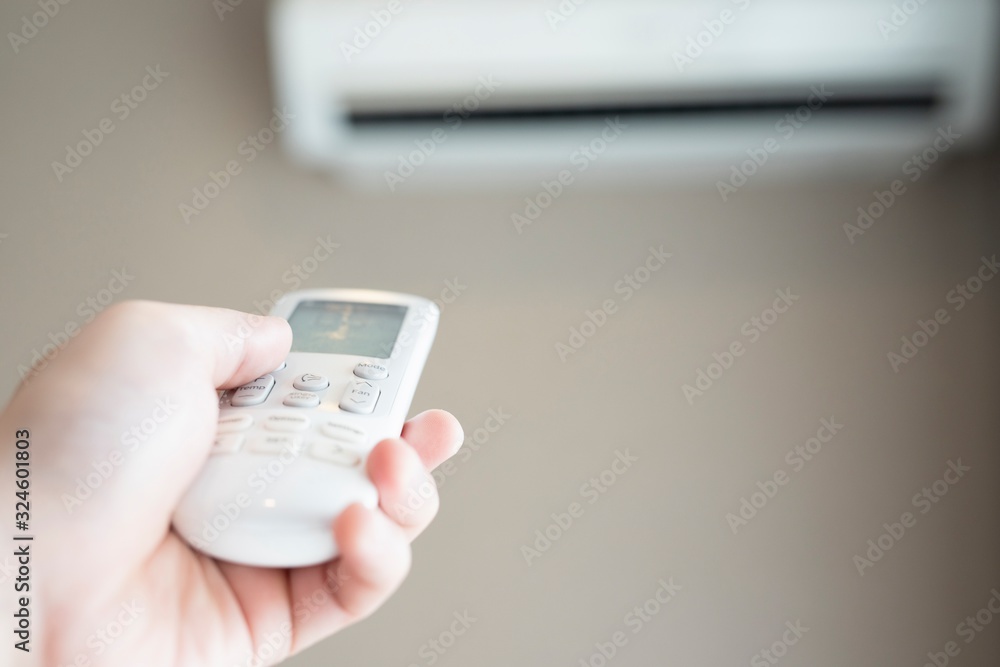 Air conditioner inside the room with operating remote controller.save world save life. Air conditioner inside the room with operating remote controller.save world save life.