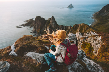 Woman relaxing alone travel in Norway adventure vacations healthy lifestyle backpacking Vesteralen landscape rocks and sea aerial view