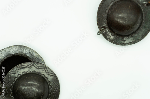 Top view of Krakebs. Isolated Moroccan percussion instrument on a white background with space in the middle for text. Musical instrument concept. photo