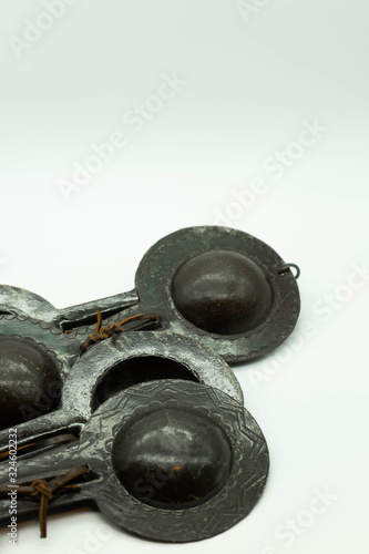 Close-up view of Krakebs. Moroccan iron percussion instruments isolated on a white background. Concept musical instrument. photo