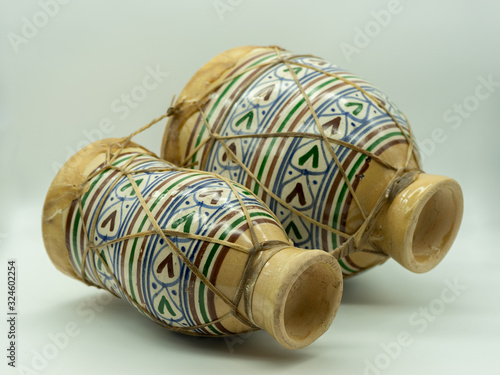 .Moroccan drums lying isolated on a white background. Traditional Moroccan instrument. Concept musical instrument. photo