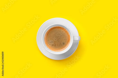 Black coffee in a cup on a yellow background