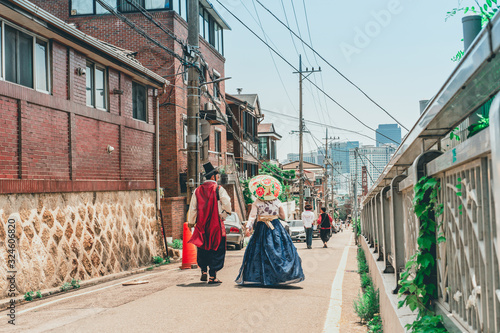 local travel with traditional house and clothing in korea from backside of travel in hanbok dress walk at landmark name is bukchon hannok