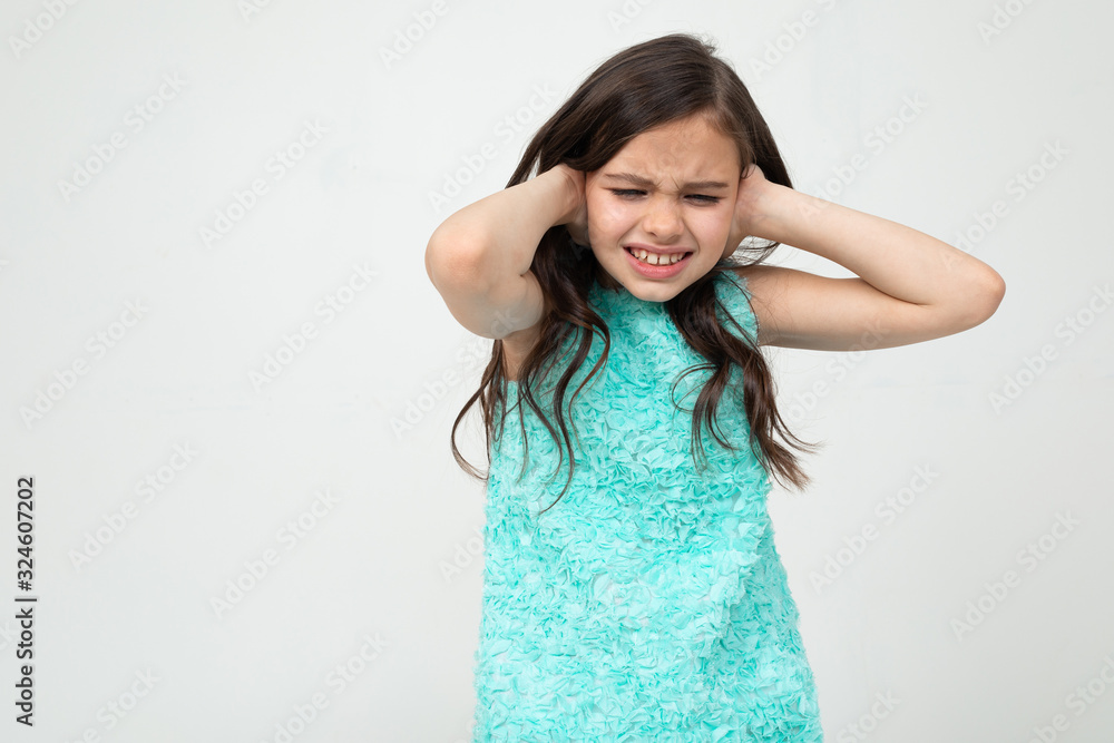 offended teenage girl in a blue dress indignant on a white studio background offended teenage girl in a blue dress indignant on a white studio background