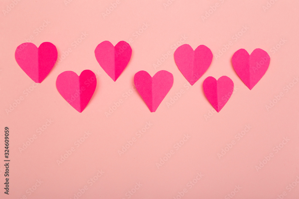 Love (Valentine's day) background or wedding background. Pink paper hearts on a pink pastel background. Love concept