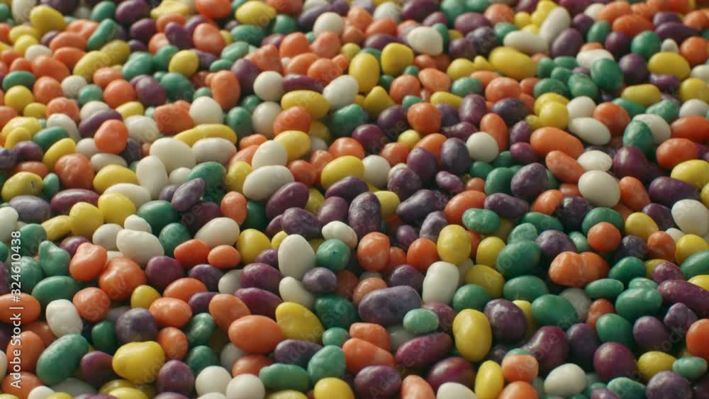 Lot of round chewy candies in multi colored glaze. Multicolored balls dragee. Slide camera movement from left to right Lot of round chewy candies in multi colored glaze. Multicolored balls dragee. Slide camera movement from left to right