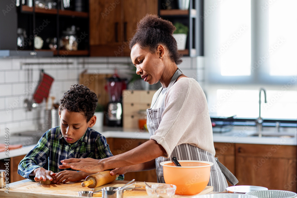 Fototapeta premium Mother with his son prepare pie in the kitchen