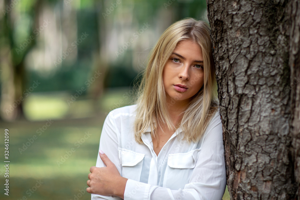 Portrait of young blonde girl in park Portrait of young blonde girl in park