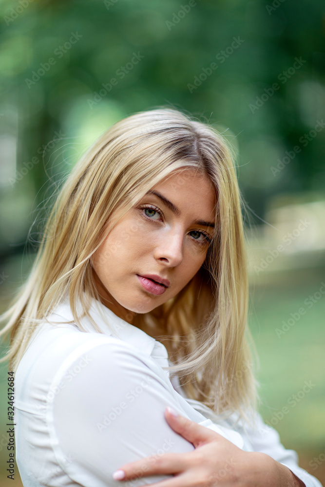 Portrait of young blonde girl in park Portrait of young blonde girl in park