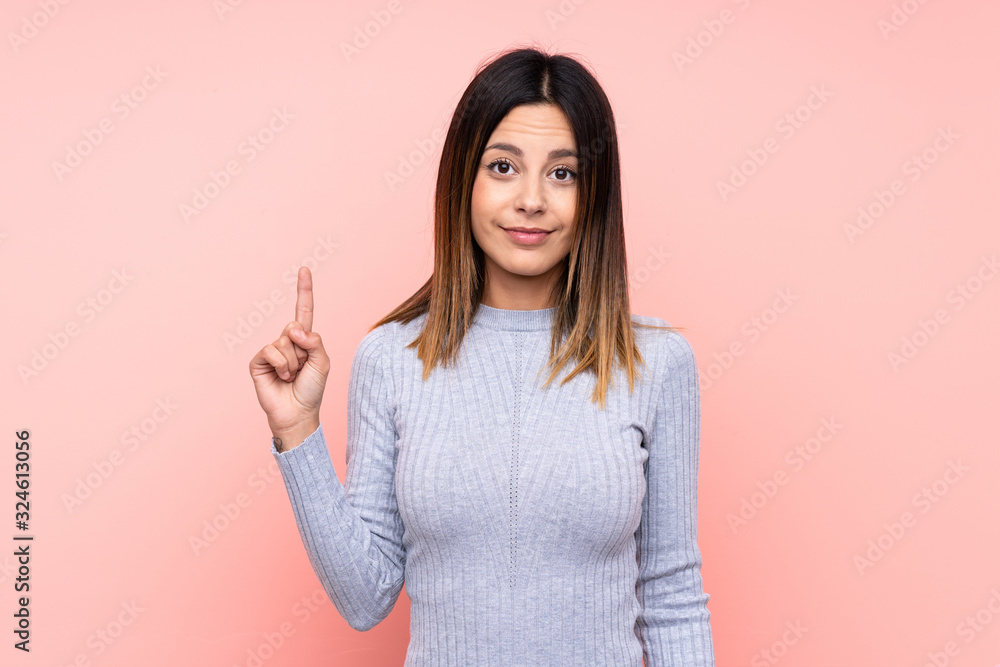 Woman over isolated pink background pointing with the index finger a great idea Woman over isolated pink background pointing with the index finger a great idea