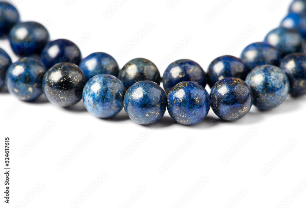 Lapis lazuli bracelet on a white background close-up. Lapis lazuli stone beads. Lapis lazuli bracelet on a white background close-up. Lapis lazuli stone beads.