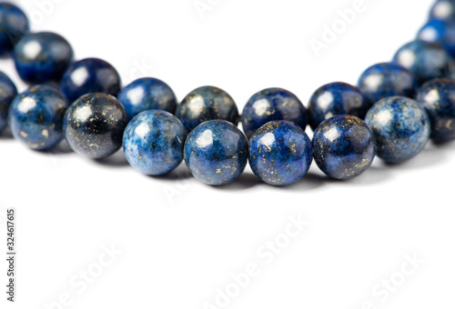 Lapis lazuli bracelet on a white background close-up. Lapis lazuli stone beads.