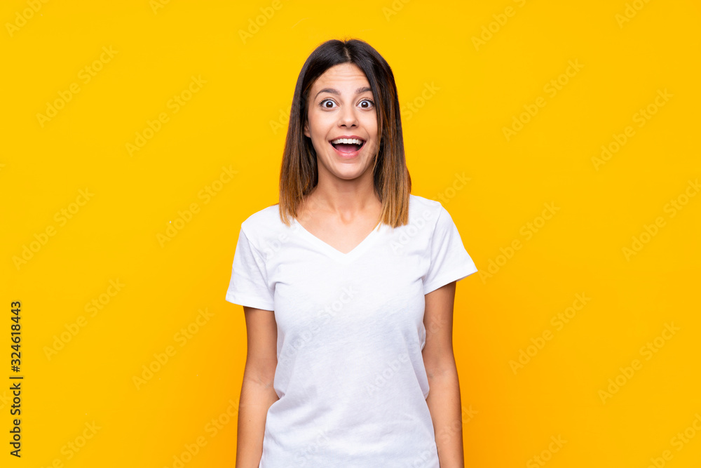 Young woman over isolated yellow background with surprise facial expression Young woman over isolated yellow background with surprise facial expression