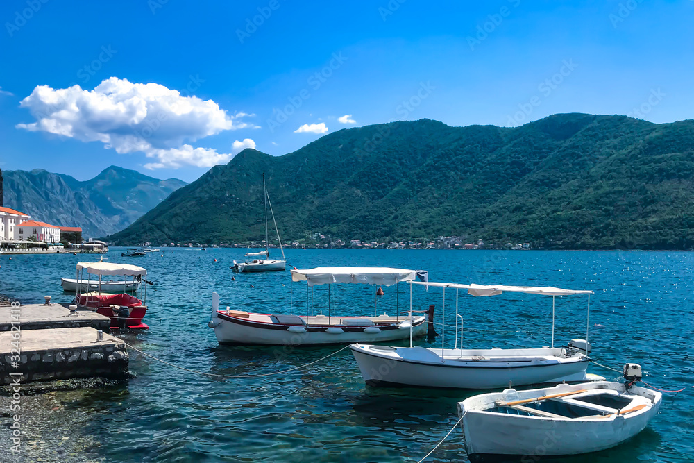 small yachts and boats stand on the shore of the city of Perast Kotor Bay Montenegro, Adriatic Sea. Summer 2019