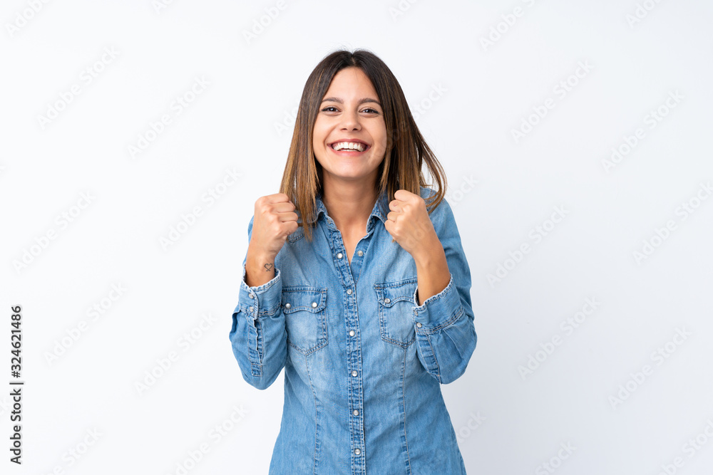 Young woman over isolated white background celebrating a victory in winner position Young woman over isolated white background celebrating a victory in winner position