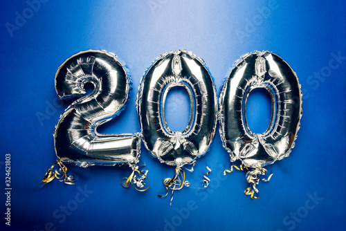 Balloon Bunting for celebration Happy 200th Anniversary made from Silver Number Balloons on blue background. Holiday Party Decoration or postcard concept with top view