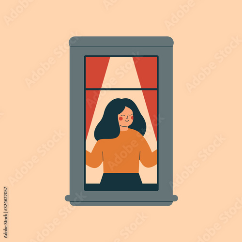 The young woman opens the window and breathes in the fresh air with pleasure. Concept of freedom