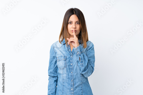 Young woman over isolated white background showing a sign of silence gesture putting finger in mouth