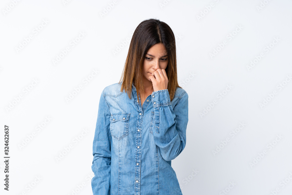 Young woman over isolated white background having doubts Young woman over isolated white background having doubts