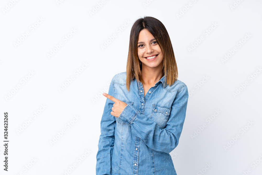Young woman over isolated white background pointing to the side to present a product Young woman over isolated white background pointing to the side to present a product