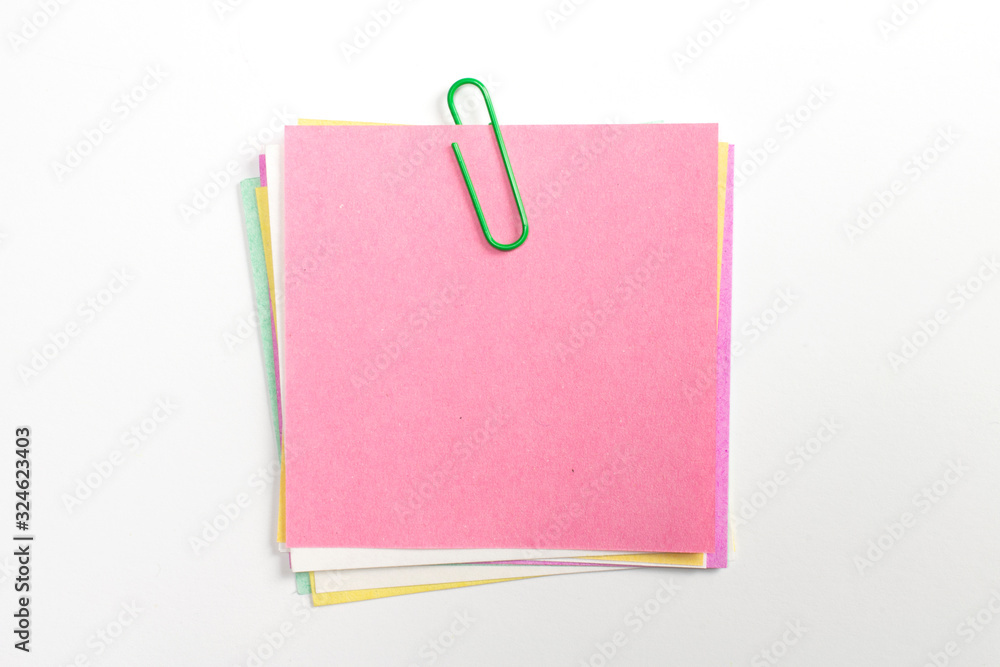 Colorful note paper pin with green paper clips and isolated on white. Colorful note paper pin with green paper clips and isolated on white.