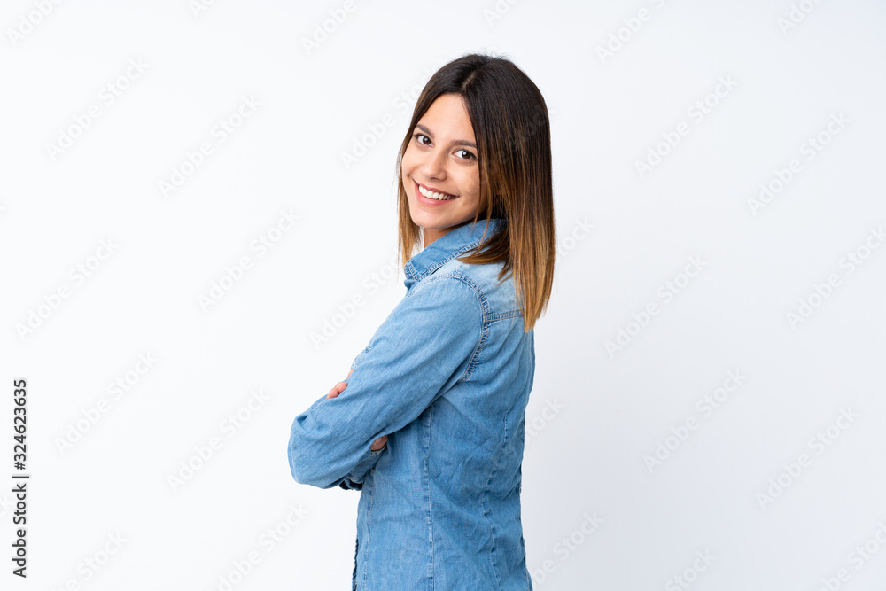 Young woman over isolated white background with arms crossed and looking forward Young woman over isolated white background with arms crossed and looking forward