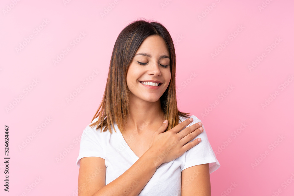 Young woman over isolated pink background Young woman over isolated pink background