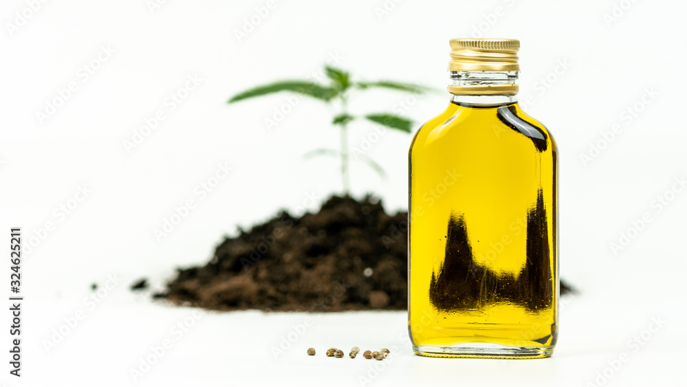 Close-up of hemp oil and cannabis seeds on white background. Essential oil made from medicinal marijuana. Close-up of hemp oil and cannabis seeds on white background. Essential oil made from medicinal marijuana.