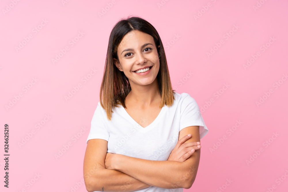 Young woman over isolated pink background keeping the arms crossed in frontal position Young woman over isolated pink background keeping the arms crossed in frontal position