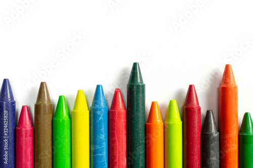 Colourful bright wax pencils isolated on white, close-up selective focus.