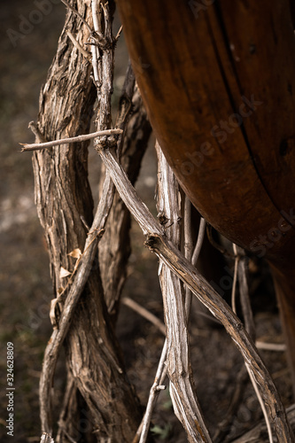 Texture Background with Dry Grey Wood Branches of Trees Tied Together. Big Bunch of Dry Branches to make Fire. The Fuel for Heating and Fireplace. Vertical photo