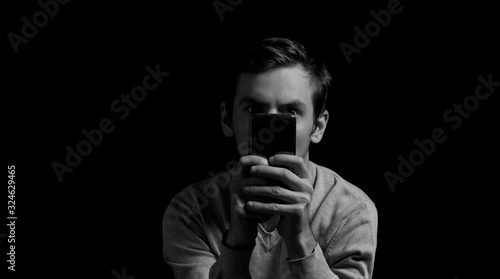 black and white photo man with a phone in his hands