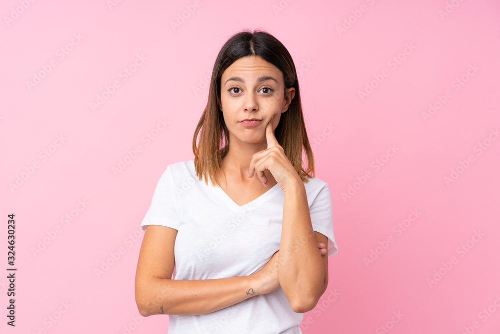 Young woman over isolated pink background Looking front Young woman over isolated pink background Looking front