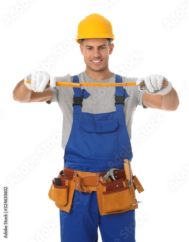 Handsome carpenter with folding rule isolated on white