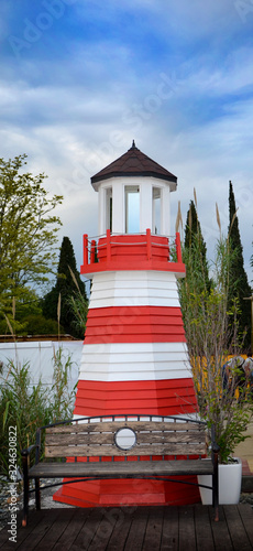 fake beautiful lighthoue on the shore photo