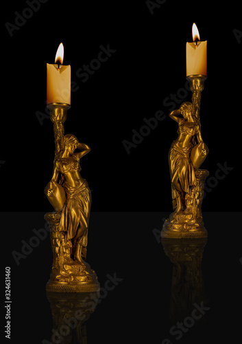 Decorative black and gold sculpture candles with flame. Romantic and relaxable ambiance.